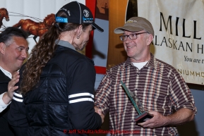 Lance Mackey (L) recieves the Donlin Gold sportsmanship award from Kurt Parkan at the finishers banquet in Nome on Sunday  March 22, 2015 during Iditarod 2015.  (C) Jeff Schultz/SchultzPhoto.com - ALL RIGHTS RESERVED DUPLICATION  PROHIBITED  WITHOUT  PERMISSION