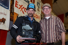 Lance Mackey (L) recieves the Donlin Gold sportsmanship award from Kurt Parkan at the finishers banquet in Nome on Sunday  March 22, 2015 during Iditarod 2015.  (C) Jeff Schultz/SchultzPhoto.com - ALL RIGHTS RESERVED DUPLICATION  PROHIBITED  WITHOUT  PERMISSION
