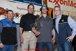 Nicolas Petit recieves the Alaska Airlnes Leonard Seppala Humanitarian Award from Pau G. Kosto, Stuart Nelson DVM --chief veterinarian, and Tim Thompson at the finishers banquet in Nome on Sunday  March 22, 2015 during Iditarod 2015.  (C) Jeff Schultz/SchultzPhoto.com - ALL RIGHTS RESERVED DUPLICATION  PROHIBITED  WITHOUT  PERMISSION