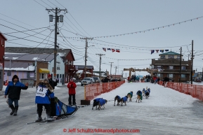 Cindy Gallea runs down Front Street into the finish chute in Nome on Sunday  March 22, 2015 during Iditarod 2015.  (C) Jeff Schultz/SchultzPhoto.com - ALL RIGHTS RESERVED DUPLICATION  PROHIBITED  WITHOUT  PERMISSION