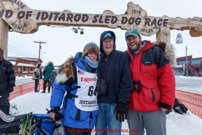 After finishing the race, Cindy Gallea poses at the finish line with her father Jim and her son Jim in Nome on Sunday  March 22, 2015 during Iditarod 2015.  (C) Jeff Schultz/SchultzPhoto.com - ALL RIGHTS RESERVED DUPLICATION  PROHIBITED  WITHOUT  PERMISSION