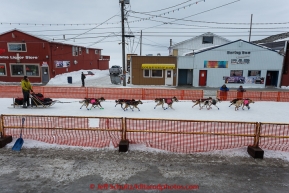 Trent Herbst runs down Front Street toward the finish line in Nome on Sunday  March 22, 2015 during Iditarod 2015.  (C) Jeff Schultz/SchultzPhoto.com - ALL RIGHTS RESERVED DUPLICATION  PROHIBITED  WITHOUT  PERMISSION