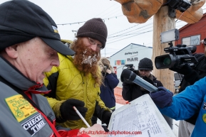 Trent Herbst signs in at the finish line in Nome on Sunday  March 22, 2015 during Iditarod 2015.  (C) Jeff Schultz/SchultzPhoto.com - ALL RIGHTS RESERVED DUPLICATION  PROHIBITED  WITHOUT  PERMISSION