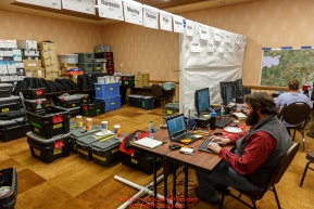 Race Comms coordinator Reece J. Roberts configures a checkpoint laptop at the race headquarters at the Lakefront Anchorage hotel on Thursday March 2, 2017 two days prior to Iditarod 2017 as other comms gear headed out to checkpoints waits to be worked on.Photo by Jeff Schultz/SchultzPhoto.com  (C) 2017  ALL RIGHTS RESVERVED