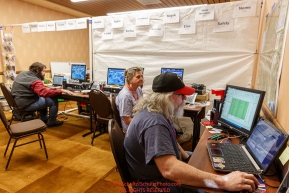 Race Comms volunteers Bryan Nelson, Patty Montague and Reece J. Roberts configure checkpoint computers at the race headquarters at the Lakefront Anchorage hotel on Thursday March 2, 2017 two days prior to Iditarod 2017.Photo by Jeff Schultz/SchultzPhoto.com  (C) 2017  ALL RIGHTS RESVERVED