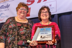 Iditarod Foundation member, Gail Phillips (left) gives the