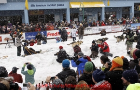 Saturday, March 3, 2012  Jeff King waves to the crowd as he passes the press as he leaves the chute on 4th avenue during the Ceremonial Start of Iditarod 2012 in Anchorage, Alaska.