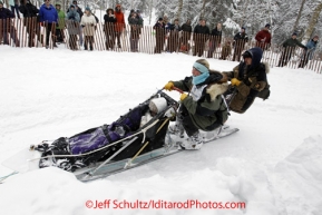 Saturday, March 3, 2012  Colleen Robertia handles her sled with ease at turn near Goose Lake during the Ceremonial Start of Iditarod 2012 in Anchorage, Alaska.