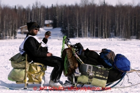 Nicolas Petit sits on his sled on Long Lake after leaving the re-start line of the Iditarod sled dog race in Willow, Alaska Sunday, March 3, 2013.