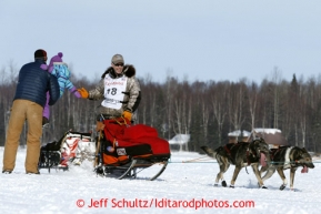 Jeff King gives a high-five to a spectator on Long Lake after leaving the re-start line of the Iditarod sled dog race in Willow, Alaska Sunday, March 3, 2013.