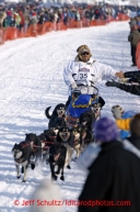 Mike Williams runs down the chute after leaving the restart on Willow lake at the restart of the Iditarod sled dog race Sunday, March 3, 2013.