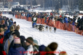 Christine Roalofs runs down the chute after leaving the restart on Willow lake at the restart of the Iditarod sled dog race Sunday, March 3, 2013.