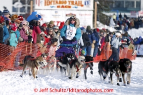 Angie Taggart runs down the chute on Willow Lake after leaving the re-start line of the Iditarod sled dog race in Willow, Alaska Sunday, March 3, 2013.