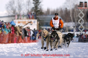 Linwood Fiedler runs down the chute on Willow Lake after leaving the re-start chute in Willow, Alaska at the restart of the Iditarod sled dog race Sunday, March 3, 2013.