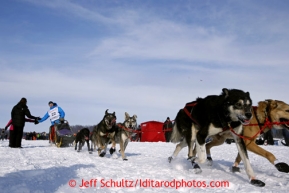 Travis Beals gives high-fives to spectators on Long Lake after leaving the re-start line of the Iditarod sled dog race in Willow, Alaska Sunday, March 3, 2013.