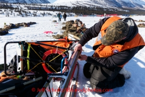 Jake Berkowitz does a sled repair at the Rainy Pass checkpoint on Puntilla Lake on Monday  March 3, 2014 during the Iditarod Sled Dog RacePhoto by Jeff Schutz/IditarodPhotos.com