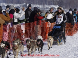 Sunday, March 4, 2012  Kristy Berrington high fives spectators in the starting chute during the restart of Iditarod 2012 in Willow, Alaska.