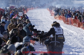Sunday, March 4, 2012  Ken Anderson high fives spectators in the starting chute at the restart of Iditarod 2012 in Willow, Alaska.