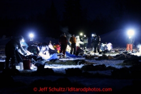Volunteers check in mushers and teams at the Finger Lake checkpoint early Monday, March 4, 2013.