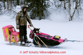 Wade Marrs of Wasilla brings his dog Pumpkin into the Finger Lake checkpoint in the sled March 4, 2013.
