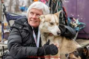 One of the teachers for the conferences making a new friend while at the mandatory pre-race veterinary checkup held at Iditarod headquarters in Wasilla on Wednesday March 4, 2015 during the 2015 Iditarod(C) Jeff Schultz/SchultzPhoto.com - ALL RIGHTS RESERVED DUPLICATION  PROHIBITED  WITHOUT  PERMISSION