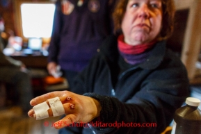 Karen Ramstead has her broken hand wrapped by a vet in Rohn during the 2014 IditarodPHOTO BY JEFF SCHULTZ / IDITARODPHOTOS.COM  DO NOT REPRODUCE WITHOUT PERMISSION