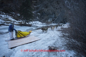 Hans Gatt crosses a plywood bridge in the Dalzell Gorge on his way to Rohn on Monday March 3 during Iditarod 2014 . PHOTO BY JEFF SCHULTZ/IDITARODPHOTOS.COM  USE ONLY WITH PERMISSION