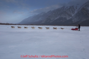 Matt Ellis runs on the ice of the South Fork of the Kuskokwim on Tuesday March 4 during Iditarod 2014 . PHOTO BY JEFF SCHULTZ/IDITARODPHOTOS.COM  USE ONLY WITH PERMISSION