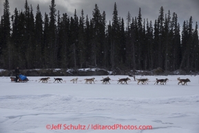 Christian Turner runs on the ice of the South Fork of the Kuskokwim shorlty after leaving Rohn Iditarod 2014 . PHOTO BY JEFF SCHULTZ/IDITARODPHOTOS.COM  USE ONLY WITH PERMISSION