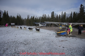 Monica Zappa runs past airplanes parked at Rohn on Tuesday March 4 during Iditarod 2014 . PHOTO BY JEFF SCHULTZ/IDITARODPHOTOS.COM  USE ONLY WITH PERMISSION