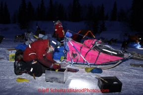 Monday March 5, 2012  A musher pours Heet into a cooker at the Finger Lake checkpoint during Iditarod 2012.