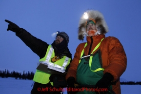 Monday March 5, 2012  Tim Johnson checking in Kelly Maixner at the Finger Lake checkpoint during Iditarod 2012.