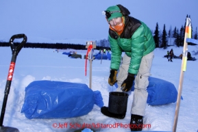 Monday March 5, 2012  Kelly Maixner gets water at the Finger Lake checkpoint during Iditarod 2012.