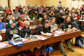 Mushers listen to speakers at the mandatory musher meeting on Thursday March 5, 2015 at the Millennium Hotel race headquarters in Anchorage.  Iditarod 2015 (C) Jeff Schultz/SchultzPhoto.com - ALL RIGHTS RESERVED DUPLICATION  PROHIBITED  WITHOUT  PERMISSION