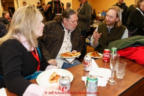 Justin Savidas has lunch with his Iditarider at the mandatory musher meeting on Thursday March 5, 2015 at the Millennium Hotel race headquarters in Anchorage.  Iditarod 2015 (C) Jeff Schultz/SchultzPhoto.com - ALL RIGHTS RESERVED DUPLICATION  PROHIBITED  WITHOUT  PERMISSION