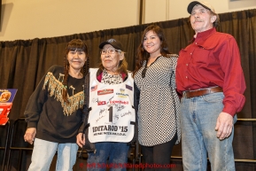 Dora Esai wears bib #1 standing in for her husband an honorary musher Philip Esai, along with her daughters Marty Runkle & Jacque Esai and her son-in-law John Runkle at the musher drawing banquet & drawing on Thursday March 5, 2015 at the Denaina Center in Anchorage, Alaska.  Iditarod 2015 (C) Jeff Schultz/SchultzPhoto.com - ALL RIGHTS RESERVED DUPLICATION  PROHIBITED  WITHOUT  PERMISSION