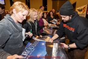 Musher Rick Casillo signs his autograph on a poster for race fans lined up at the musher banquet & drawing on Thursday March 5, 2015 at the Denaina Center in Anchorage, Alaska.  Iditarod 2015 (C) Jeff Schultz/SchultzPhoto.com - ALL RIGHTS RESERVED DUPLICATION  PROHIBITED  WITHOUT  PERMISSION