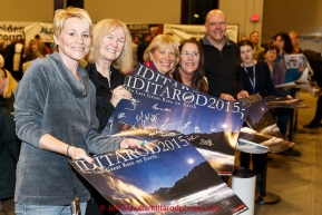 Race fans hold up their ExxonMobil posters with musher signatures at the musher banquet & drawing on Thursday March 5, 2015 at the Denaina Center in Anchorage, Alaska.  Iditarod 2015 (C) Jeff Schultz/SchultzPhoto.com - ALL RIGHTS RESERVED DUPLICATION  PROHIBITED  WITHOUT  PERMISSION