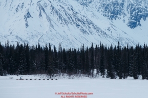 A team runs on Finger Lake with the Alaska Range in the background at the Finger Lake checkpoint during the 2018 Iditarod race on Monday March 05, 2018. Photo by Jeff Schultz/SchultzPhoto.com  (C) 2018  ALL RIGHTS RESERVED