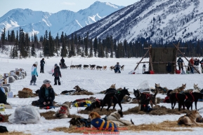 Richie Diehl runs toward the check-in tent on Puntilla Lake at the Rainy Pass checkpoint as dog teams rest in the sun during the 2018 Iditarod race on Monday March 05, 2018. Photo by Jeff Schultz/SchultzPhoto.com  (C) 2018  ALL RIGHTS RESERVED