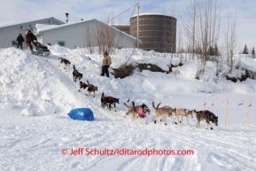 Bob Bundtzen runs down the bank onto the Kuskokwim river  as he leaves the McGrath checkpoint on Wednesday March 5 during the 2014 IditarodPHOTO BY JEFF SCHULTZ / IDITARODPHOTOS.COM  DO NOT REPRODUCE WITHOUT PERMISSION