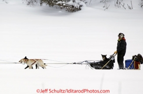 Tuesday March 6, 2012 Ryan Redington arrives in the Nikolai checkpoint with a dog in his sled, Iditarod 2012.