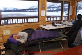 Tuesday March 6, 2012  Volunteer helper Chris Blankenship catches some Z's in the morning as Comm's volunteers check trail traffic at the Rainy Pass checkpoint, Iditarod 2012.