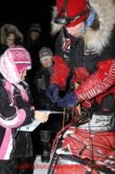 Tuesday March 6, 2012 Aliy Zirkle arrived first to the McGrath checkpoint in the Iditarod 2012, winning the PenAir Spirit of Alaska Award. Kendra Chase, age 8, from McGrath took the opportunity to ask for Aliy's autograph.