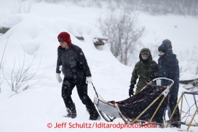 Musher Michelle Phillips drags her extra sled up to her team at Takotna Wednesday March 6, 2013.Iditarod Sled Dog Race 2013Photo by Jeff Schultz copyright 2013 DO NOT REPRODUCE WITHOUT PERMISSION