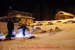 Husband and wife Aliy Zirkle and Allen Moore talk as teams restduring their 24 hour layover at the Tokotna checkpoint just before dawn on Wednesday March 6, 2013.Iditarod Sled Dog Race 2013Photo by Jeff Schultz copyright 2013 DO NOT REPRODUCE WITHOUT PERMISSION