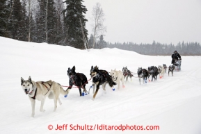 Curt Perano drives his team on the Tokotna river about a mile before the checkpoint just before dawn on Wednesday March 6, 2013.Iditarod Sled Dog Race 2013Photo by Jeff Schultz copyright 2013 DO NOT REPRODUCE WITHOUT PERMISSION