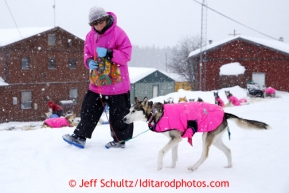 Deedee Jonrowe walks Osprey at the Tokotna checkpoint just before dawn on Wednesday March 6, 2013.Iditarod Sled Dog Race 2013Photo by Jeff Schultz copyright 2013 DO NOT REPRODUCE WITHOUT PERMISSION