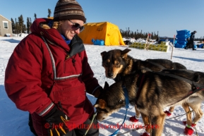 Tekla Seavey, a checker at the Cripple checkpoint, interacts with one of MItch Seavey's dogs on Thursday, March 6, during the Iditarod Sled Dog Race 2014.PHOTO (c) BY JEFF SCHULTZ/IditarodPhotos.com -- REPRODUCTION PROHIBITED WITHOUT PERMISSION