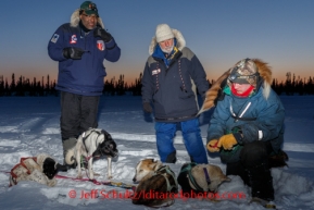 Volunteer veterinarians Bruce Nwadike and Bill Sampson look over Wade Marrs at the Cripple checkpoint, Thursday, March 6, during the Iditarod Sled Dog Race 2014.PHOTO (c) BY JEFF SCHULTZ/IditarodPhotos.com -- REPRODUCTION PROHIBITED WITHOUT PERMISSION